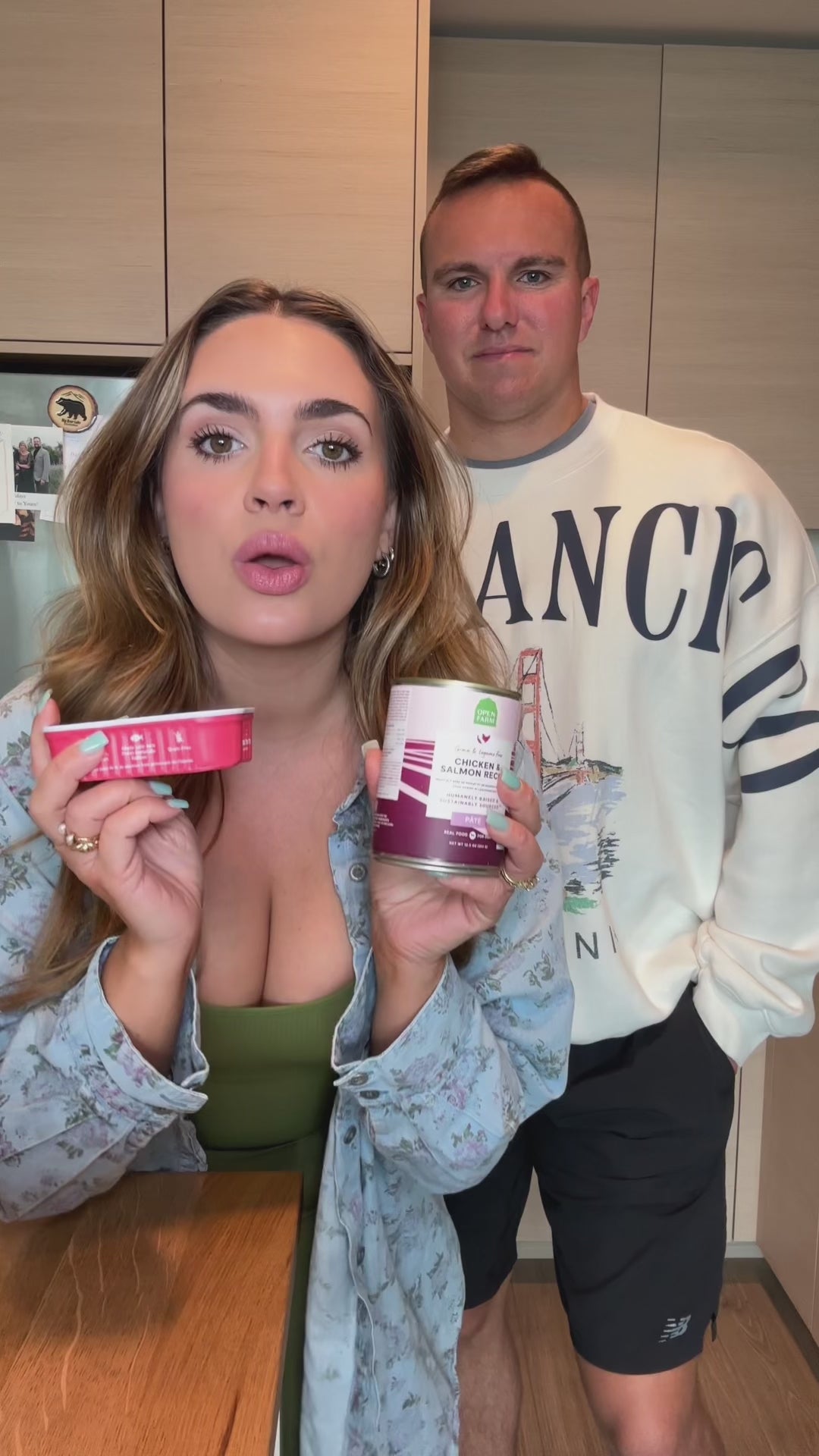 video of a women, man and her dog serving her dog wet food for a meal